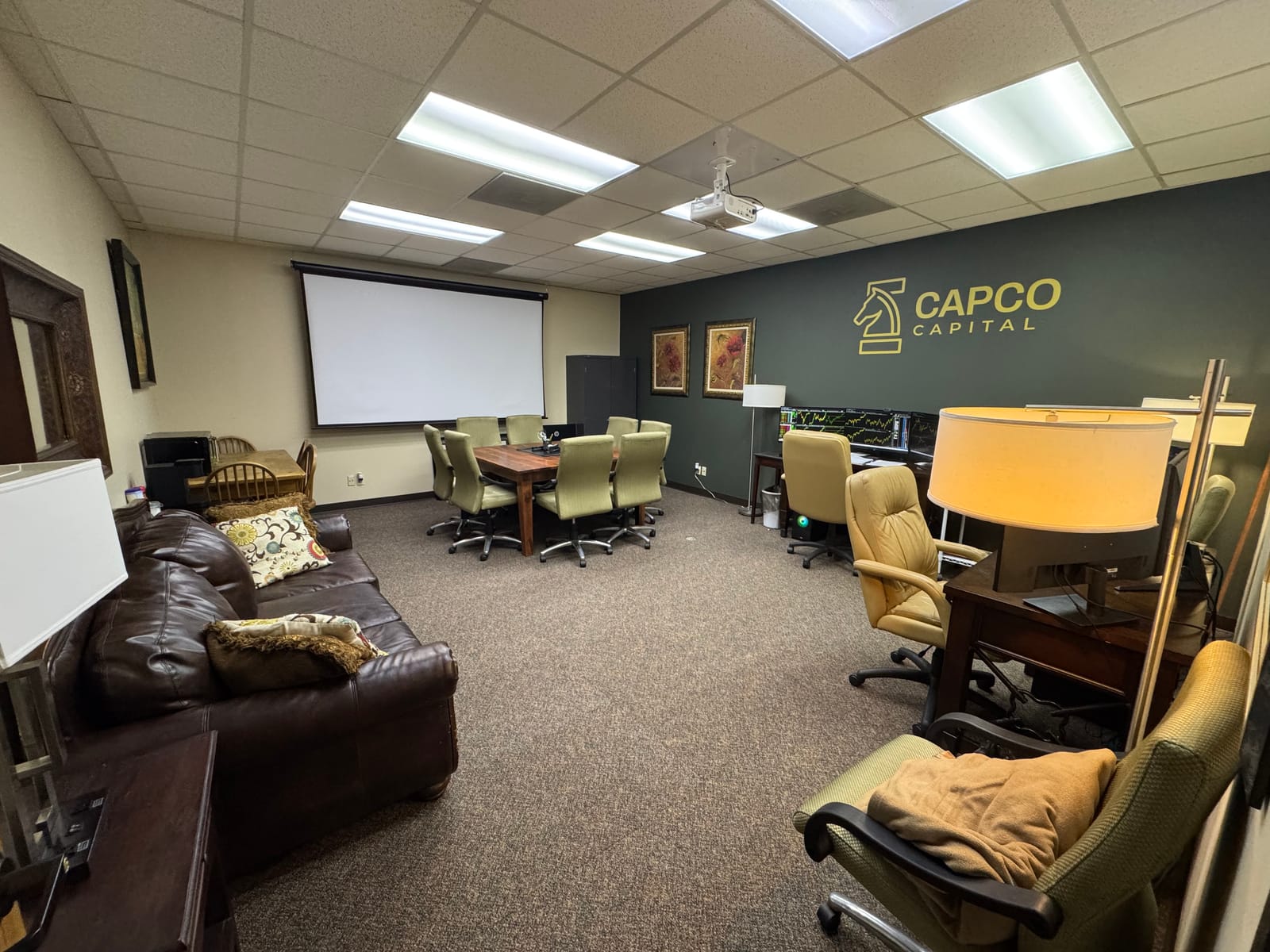 Inside the Capco Capital office with the gold knight logo on the wall
